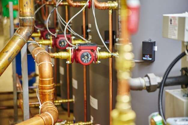 industrial copper piping with red valve closeup