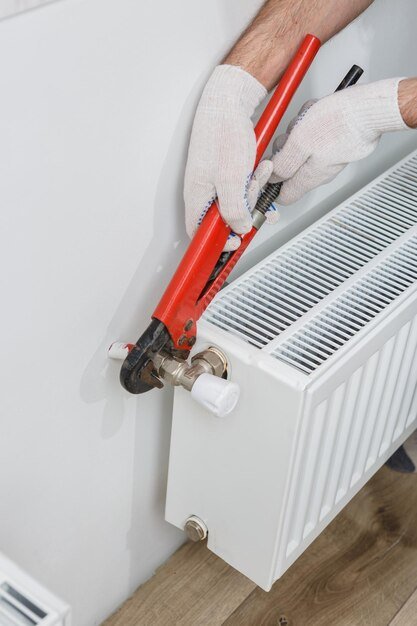 worker orange helmet installs radiators house